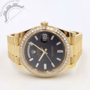 Tarjolle häpeilemättömän upea Rolex Day-Date 40. Upealla mustalla taululla jossa päivä ja päivämäärä näytöt, kultaiset osoittimet sekä baguette hiotut timantti-indeksit. 18K keltakultaa oleva kuori jossa tehdasasenteinen timanttibezel. Kokonaisuuden kruunaa 18K keltakultaa oleva president-ranneke. Koneistona toimii Rolex 3255 -automaatti jossa 70h käyntivara. Täydellinen Full set alkuperäistä ostokuittia myöden. Kellon takuukortti on päivätty 3/2023. Kellon ovh. 113 300e.